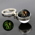 Luminous Gemini zodiac glass ball keychain with silver metal ring and green glow effect - Gemini