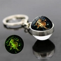 Luminous Leo zodiac double-sided glass ball keychain with green night glow effect - Leo