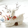 Detail of plush Christmas reindeer with white embroidery and festive striped scarf - Lying Plush Reindeer Style