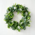 Close-up of artificial eucalyptus wreath with white flowers on white wooden background - Eucalyptus White Small Floral Style B