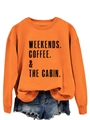 Detail of orange sweatshirt with weekends coffee cabin print and ripped denim shorts - Orange Sweatshirt (Black Letters)
