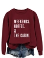 Close-up of Weekends Coffee & The Cabin slogan print on burgundy crewneck sweatshirt - Wine Red (White Letters)