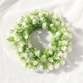 Artificial spring wreath with white flowers and green leaves on white fabric - White Gypsophila Style