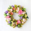Artificial spring wreath with pink and orange tulips on a white wood background - Mixed Rose Wreath Style