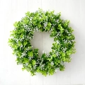 Green eucalyptus leaf wreath with white baby's breath flowers on white wooden background - Lush Eucalyptus White Flower Style