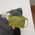 Minimalist grass green faux suede crossbody bag with heart zippers in a chic lifestyle set - Green