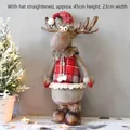 Detail view of plush reindeer Christmas doll with red plaid vest and knit hat ornaments - Scottish Female Deer