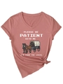 Close-up of V-neck dusty pink cotton T-shirt with vintage carriage print and tied hem detail - S / Rose Gold