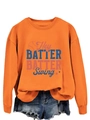 Flat lay of an orange Hey Batter Batter Swing sweatshirt with frayed denim shorts - S / Orange
