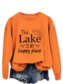 Detail of orange sweatshirt with The Lake IS MY happy place text print and graphics - Orange (Black Print)