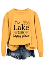 Close-up of yellow sweatshirt with The Lake Is My Happy Place print and sun graphics - Yellow (Black Print)