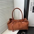 Caramel suede tote bag with leather handles and gold buckle in a minimalist home setting - Brown