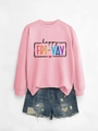 Detail of pink long sleeve sweatshirt with colorful happy fri-yay lettering and denim shorts - Pink Sweatshirt (Black Text)