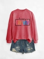 Close-up of Happy Friday print on red long sleeve sweatshirt with denim shorts - Red Sweatshirt (Black Text)