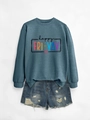 Flat lay of Happy Fri-Yay crewneck sweatshirt paired with distressed denim shorts - Blue Sweatshirt (Black Text)