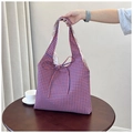 Close-up of blue and orange checkered tote bag featuring a floral lining and tie closure - Orange Blue Reverse
