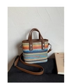 Close-up of rainbow woven tote bag featuring leather handles and silver metal hardware - Square Tote Style (Style 2)