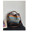 Detail of colorful woven bucket bag featuring brown leather handles and adjustable strap - Half-moon Bucket Style (Style 1)