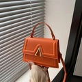 Retro orange shoulder bag with gold A-shaped buckle and embossed details - Orange