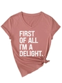 Detail of V-neck T-shirt showing First Of All I'm A Delight print and side knot hem - Rose Gold (White Print)