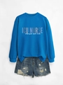 Flat lay of royal blue ICU Nurse sweatshirt paired with distressed denim shorts - Lake Blue (White Print)
