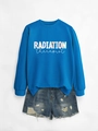 Close-up of blue radiation therapist sweatshirt with denim shorts on grey background - Lake Blue Sweatshirt (White Graphic)