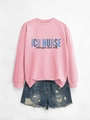 Detail of pink ICU NURSE sweatshirt paired with distressed denim shorts on gray background - Pink (Black Print)