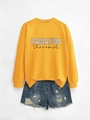 Flat lay of a yellow Radiation Therapist sweatshirt paired with distressed denim shorts - Yellow Sweatshirt (Black Text)