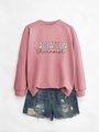 Flat lay of pink radiation therapist sweatshirt paired with distressed blue denim shorts - Rose Gold Sweatshirt (Black Text)