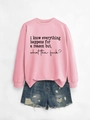 Flat lay of pink crewneck sweatshirt with black slogan print and ripped denim shorts - Pink Sweatshirt (Black Font)