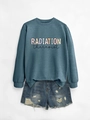 Detail of Radiation Therapist crewneck sweatshirt paired with distressed denim shorts - Blue Sweatshirt (Black Text)