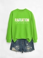 Close-up of radiation therapist print on bright green sweatshirt with denim shorts - Neon Green Sweatshirt (White Graphic)