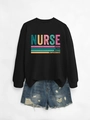 Flat lay of black crewneck nurse sweatshirt featuring caring loyal strong graphic text - Black