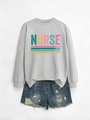 Detailed flat lay of long-sleeve nurse sweatshirt with blue distressed denim shorts - Gray