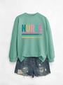 Detail of mint green nurse sweatshirt paired with distressed blue denim shorts - Light Green