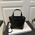 Black embossed leather tote bag with SMNL logo patterns and gold hardware detail - Black