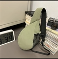 Detail view of the sage green sling bag with breathable mesh back and side pocket - Green