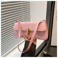 Detailed shot of pink faux leather baguette bag with elegant golden twist lock closure - Pink
