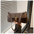 Close-up of a retro dark brown baguette bag featuring a sleek gold metal buckle clasp - Coffee