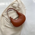 Chic caramel half-moon shoulder bag in smooth leather on an elegant white blazer - Brown