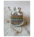 Detail of colorful woven drawstring bucket bag with large pearl handle and gold chain - Purple
