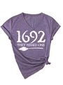 Detail of purple V-neck T-shirt with 1692 witch theme graphic and stylish side knot - S / Purple (White Font)