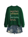 Flat lay of dark green sweatshirt with capital letters print and ripped denim shorts - Dark Green