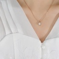 Collar minimalista de oro rosa con colgante de circón brillante sobre una modelo - Oro rosa