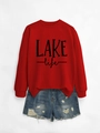 Detailed flat lay of red LAKE life sweatshirt paired with distressed denim shorts - Red Sweatshirt (Black Print)