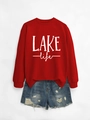 Flat lay of red LAKE life sweatshirt paired with distressed blue denim shorts - Red Sweatshirt (White Print)
