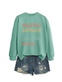 Detail of mint green sweatshirt with capital letters print and ripped denim shorts - Mint Green