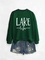 Detail of dark green Lake Life sweatshirt paired with distressed blue denim shorts - Dark Green Sweatshirt (White Print)