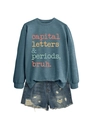 Detailed flat lay of blue crewneck sweatshirt with graphic text and ripped denim shorts - Blue