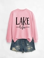 Close-up of the LAKE life graphic print on pink crewneck sweater with ribbed cuffs - Pink Sweatshirt (Black Print)